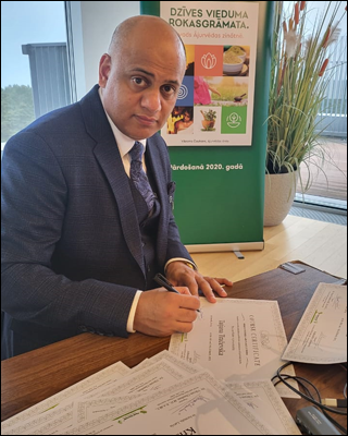 Dr. Vikram Chauhan signing the Certificates for the participants in the seminar on Ayurveda, conducted by Planet Ayurveda Latvia