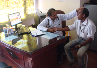 Dr. Vikram Chauhan is clinically diagnosing a patient using pulse and tongue examination techniques described in Ayurveda